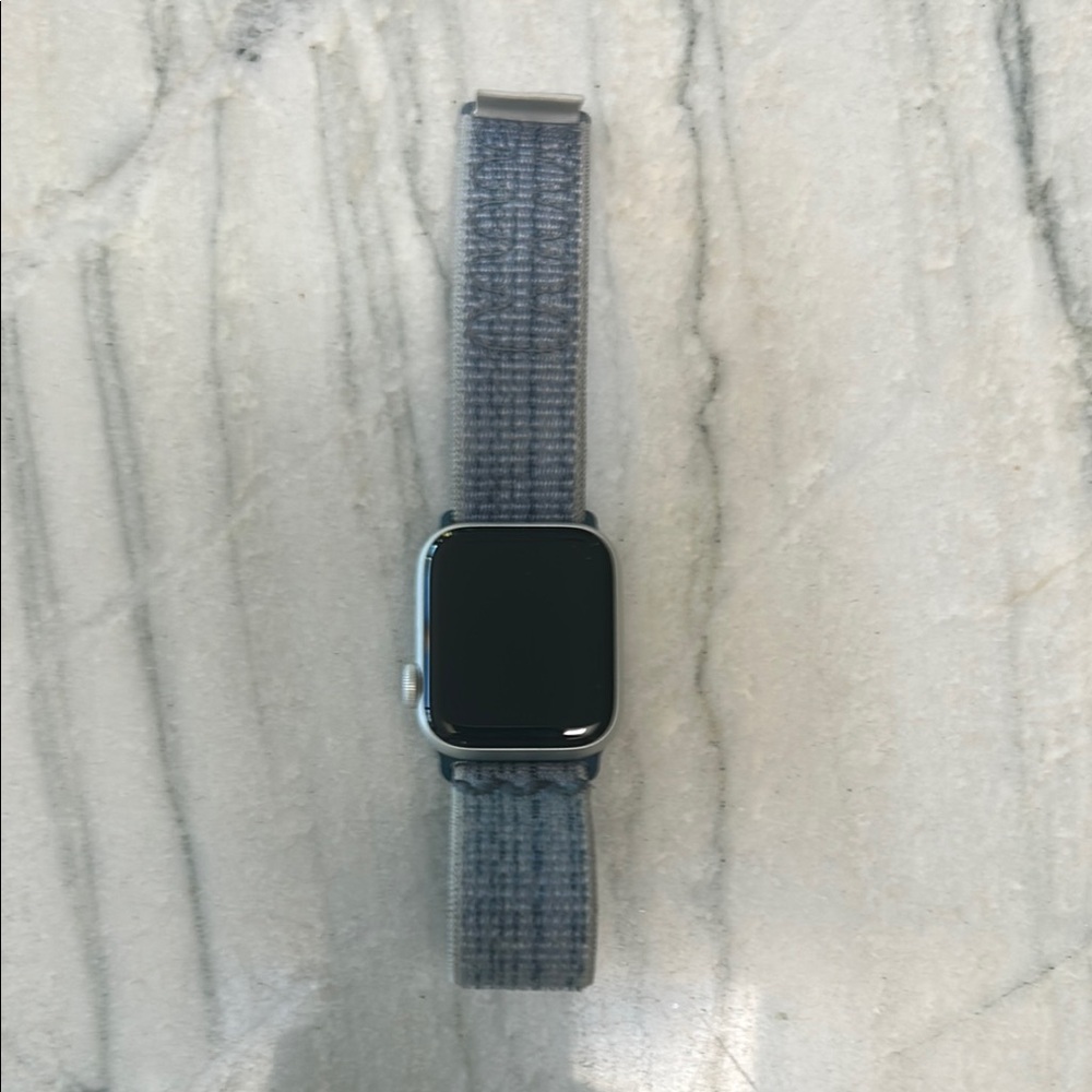 Apple Silver Smartwatch with Blueish Grey Fabric Band (can be changed).